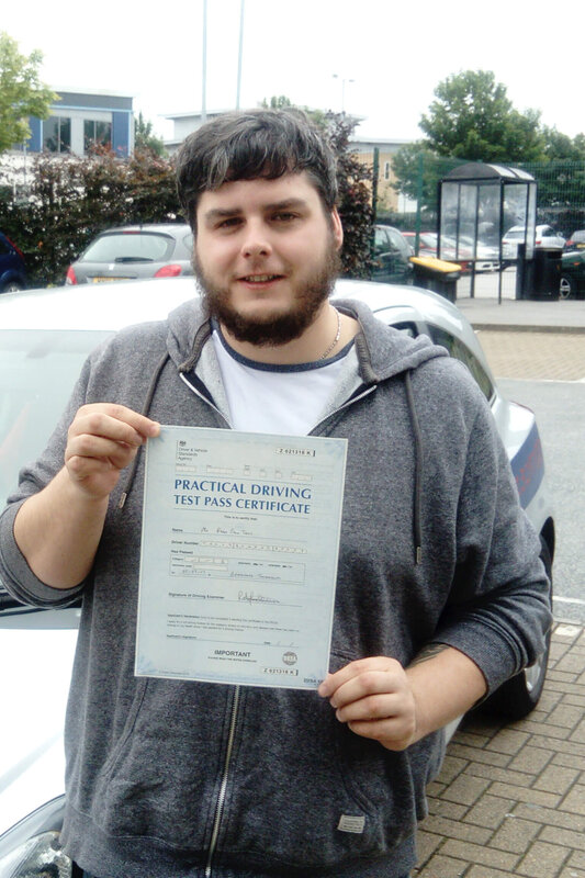 Ryan from BD2 holding his pass certificate after passing his driving test on his first attempt at Thornbury test centre in Bradford with SUX-S Driving School.