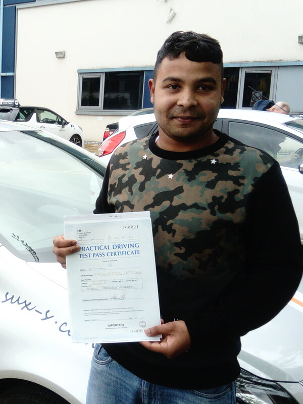Al-Amin from BD3 smiling with his pass certificate after passing his driving test on his first attempt at Thornbury test centre in Bradford with SUX-S Driving School.