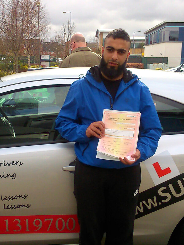 Amal from BD2 smiling with her pass certificate after passing her driving test on her first attempt at Thornbury test centre in Bradford with SUX-S Driving School.