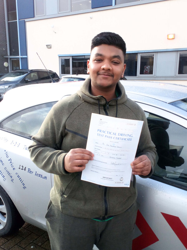 Amir from BD3 holding his pass certificate after passing his driving test on his first attempt at Thornbury test centre in Bradford with SUX-S Driving School.
