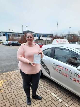Caroline from BD3 holding her pass certificate after passing her driving test on her first attempt at Thornbury test centre in Bradford with SUX-S Driving School.