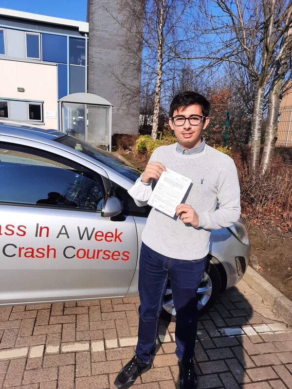 Daniel from BD3 smiling with his pass certificate after passing his driving test on his first attempt at Thornbury test centre in Bradford with SUX-S Driving School.