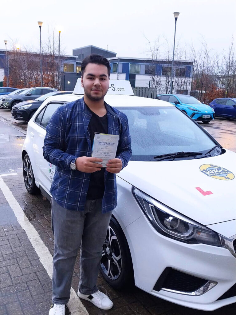 Arsh holding his driving test pass certificate after passing on his first attempt at the Thornbury test centre in BD2 Bradford with SUX-S Driving School.