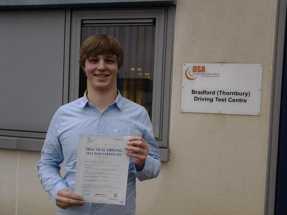 Ben proudly holding his zero-fault driving test pass certificate after passing on his first attempt with a clean sheet at Thornbury test centre in BD3, serving BD10 Bradford with SUX-S Driving School.