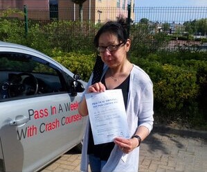 Jacki from BD18 holding her driving test pass certificate after passing her driving test with SUX-S Driving School in Bradford.