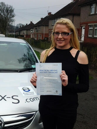 Katie holding her driving test pass certificate after passing on her first attempt at the Thornbury test centre in BD10 Bradford with SUX-S Driving School.
