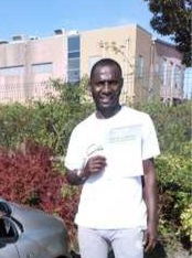 Hakim from BD4 holding his pass certificate after passing his driving test on his first attempt at Thornbury test centre in Bradford with SUX-S Driving School.