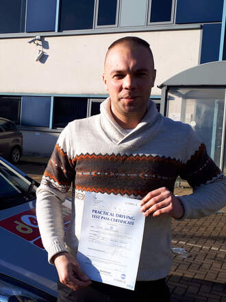 Igor from BD7 celebrating his second attempt driving test pass at Thornbury test centre in Bradford with SUX-S Driving School.