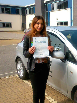 Iqra from BD5 celebrating her second attempt driving test pass at Thornbury test centre in Bradford with SUX-S Driving School.