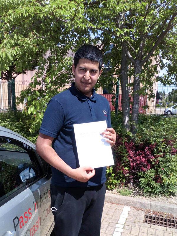 Jawad from BD5 holding his pass certificate after passing his driving test on his first attempt at Thornbury test centre in Bradford with SUX-S Driving School.