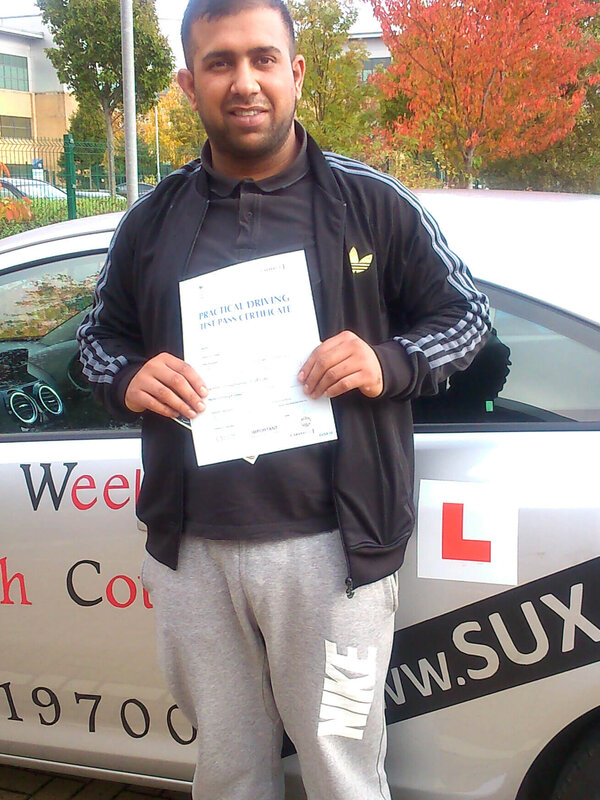 Junaid from BD2 smiling with his pass certificate after passing his driving test on his first attempt at Thornbury test centre in Bradford with SUX-S Driving School.