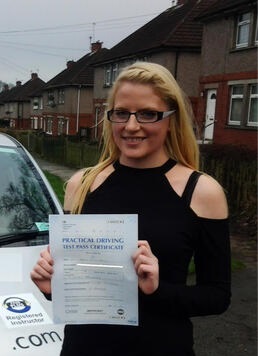 Katie from BD2 holding her pass certificate after passing her driving test on her first attempt at Thornbury test centre in Bradford with SUX-S Driving School.