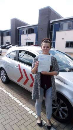 Kristina from BD5 celebrating her first time driving test pass at Thornbury test centre in Bradford with SUX-S Driving School.