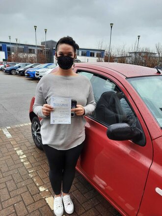 Leanne from BD4 smiling with her pass certificate after passing her driving test on her first attempt at Thornbury test centre in Bradford with SUX-S Driving School.