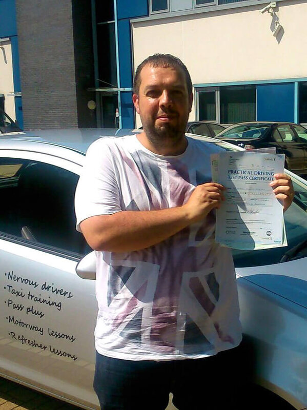 Mike from BD4 smiling with his pass certificate after passing his driving test on his first attempt at Thornbury test centre in Bradford with SUX-S Driving School.