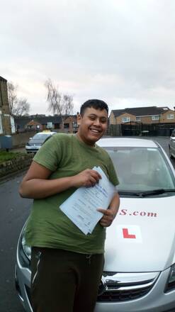 Rakibul from BD3 holding his pass certificate after passing his driving test on his first attempt at Thornbury test centre in Bradford with SUX-S Driving School.