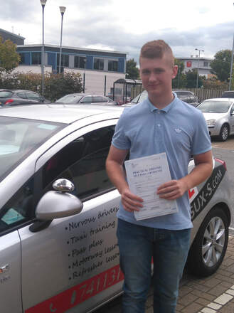 William from BD10 holding his pass certificate after passing his driving test on his first attempt at Thornbury test centre in Bradford with SUX-S Driving School.