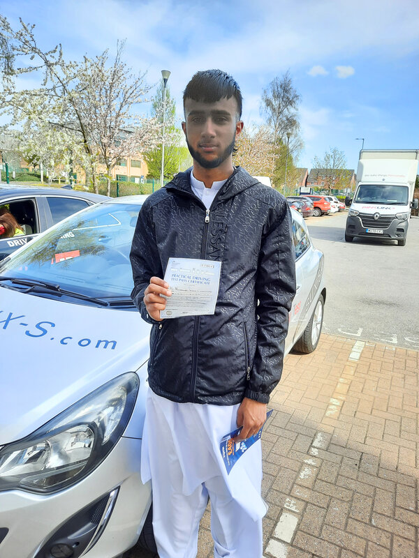 Zeeshan from BD3 holding his pass certificate after passing his driving test on his first attempt at Thornbury test centre in Bradford with SUX-S Driving School.